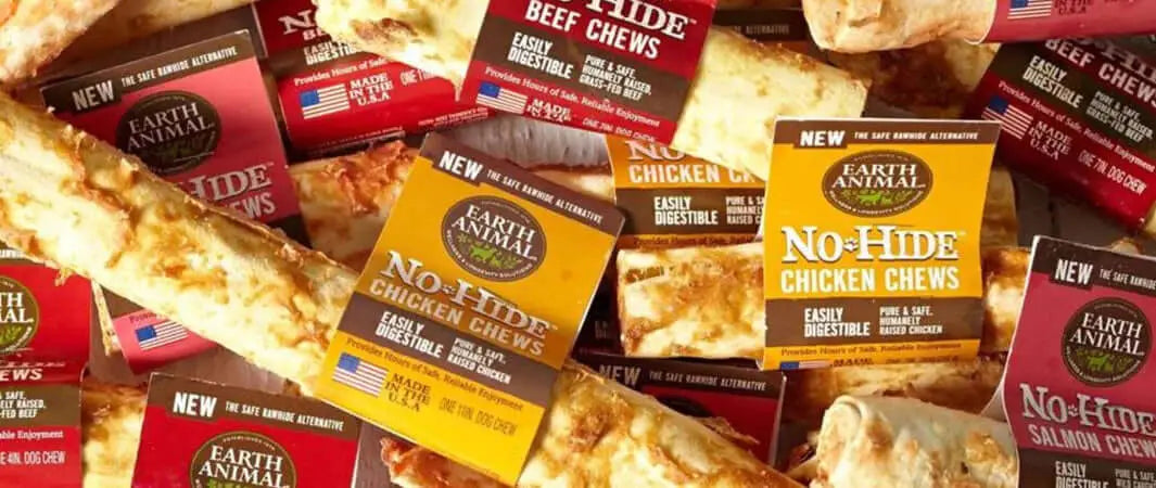 Earth Animal no-hide dog chews in yellow and brown packaging