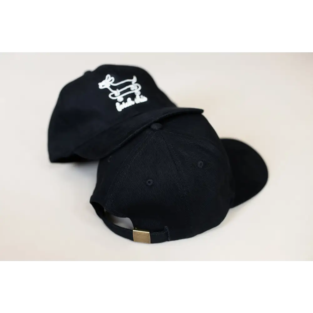 Black cotton cap with white dog design and adjustable strap for stylish outdoor wear