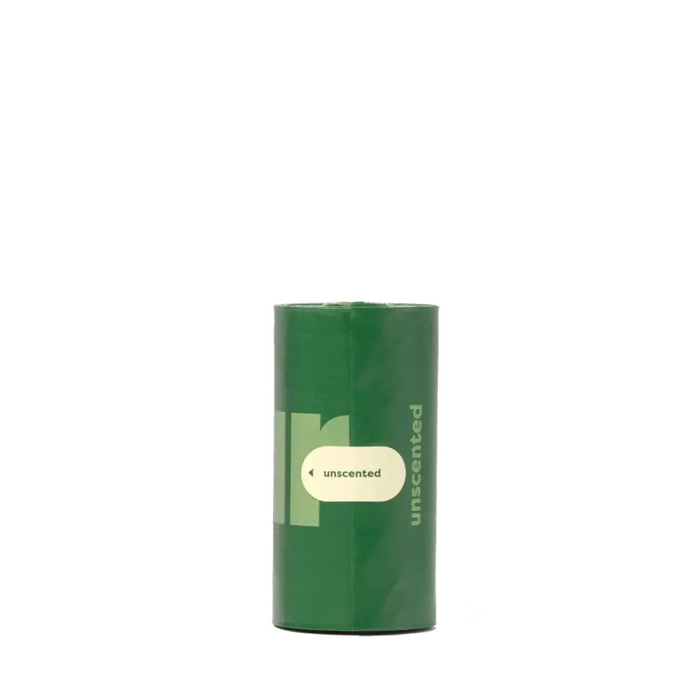 Earth Rated Poop Bags Lavender with green unscented candle in clear glass holder