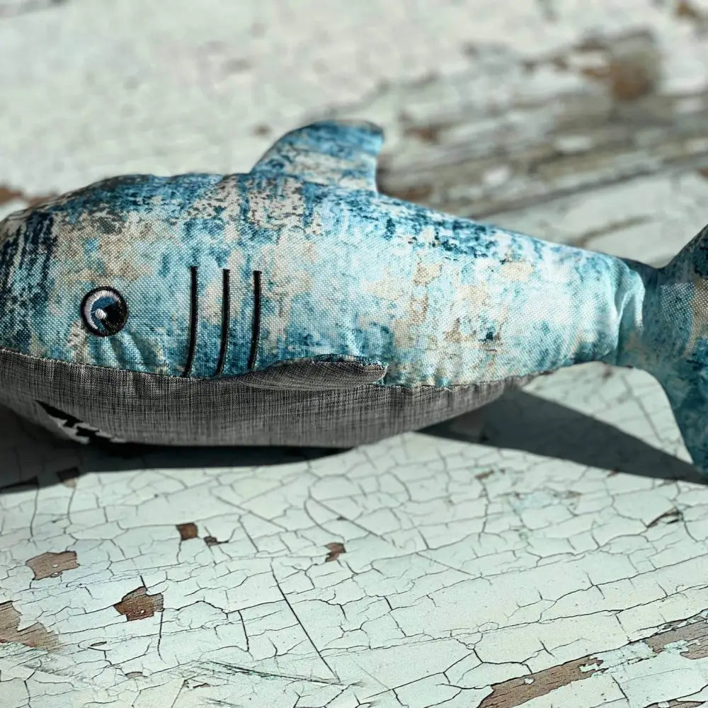 Blue eco-conscious shark dog toy from recycled plastic bottles on wood