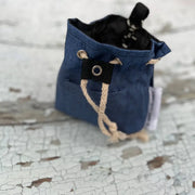Eco treat bag made with recycled materials, blue drawstring pouch with black accents and white trim