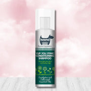 Hownd Yup You Stink Conditioning Shampoo bottle with floral design and white cap, infused with cedarwood essential oils and fox poo scent