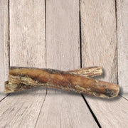 JR Pet Products Thick Bull Pizzle Chew: air dried bone-shaped pet toy in tan hues