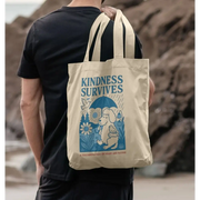 Cream-colored tote bag with elephant and bird design and kindness survives text front