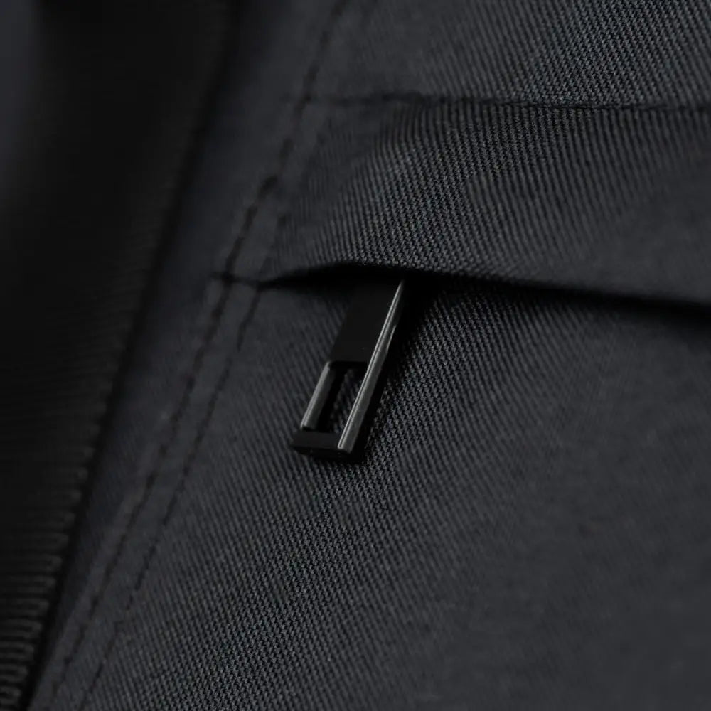 Black zipper pull on dark fabric jacket of Soho Poms Black Rainy Bear Pet Carrier
