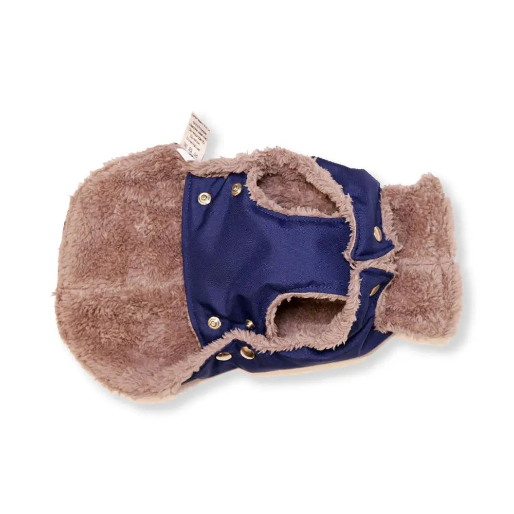 Navy blue waterproof dog jacket with tan fur trim and snap closure for Soho Poms dog