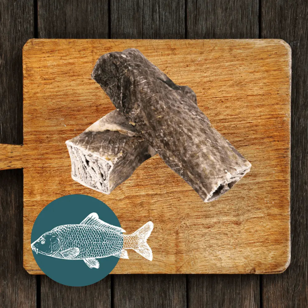 Fish stick dog treat in The Fish Chew Box on wooden board