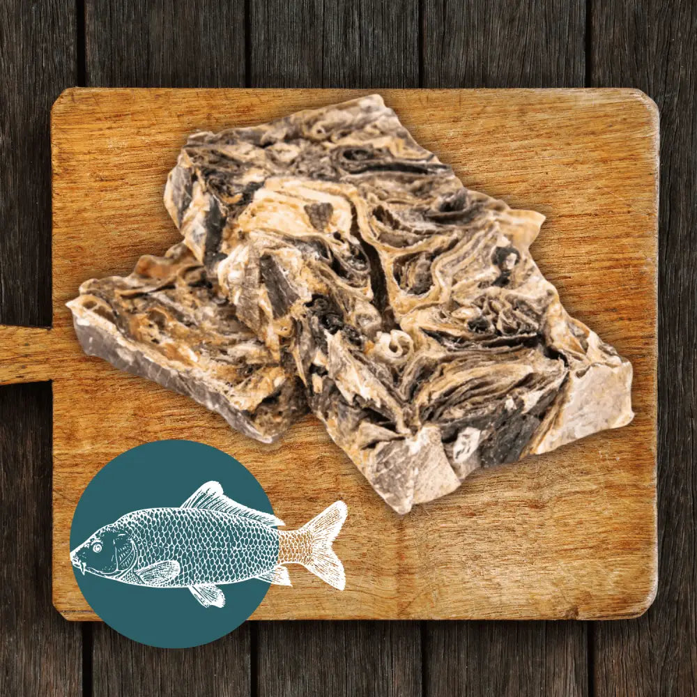 Bone-in beef short ribs on wooden board with wolf fish stick illustration for The Fish Chew Box