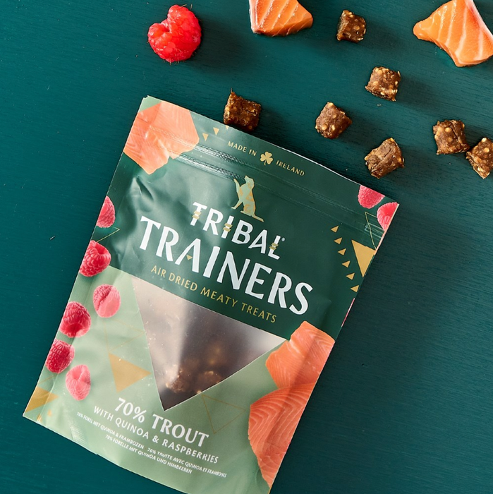 Tribal Trainers air dried meaty treats packaging on a teal background with treats around.
