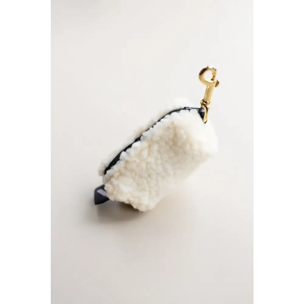 White fur keychain with black accents and solid brass hardware for Waste Bag Treat Holders