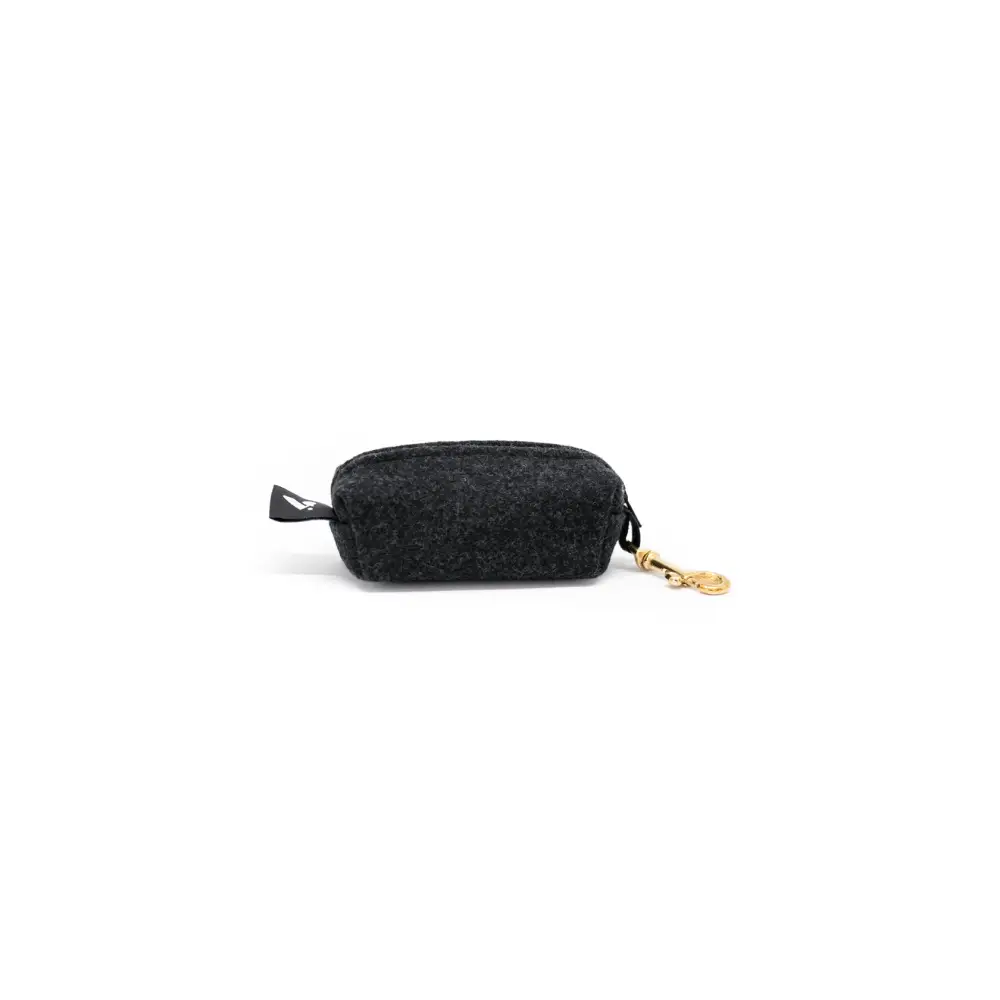 Black textured fabric pouch with gold zipper and clip featuring solid brass hardware