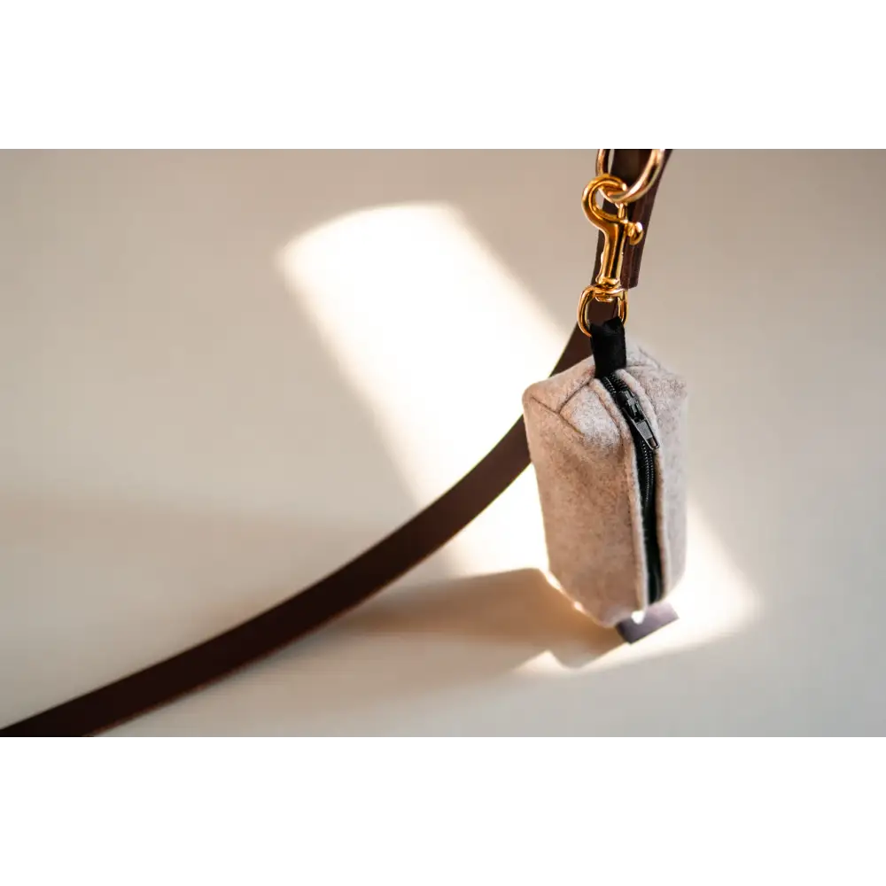 Black leather leash with solid brass hardware and white fur accent for Waste Bag Treat Holder