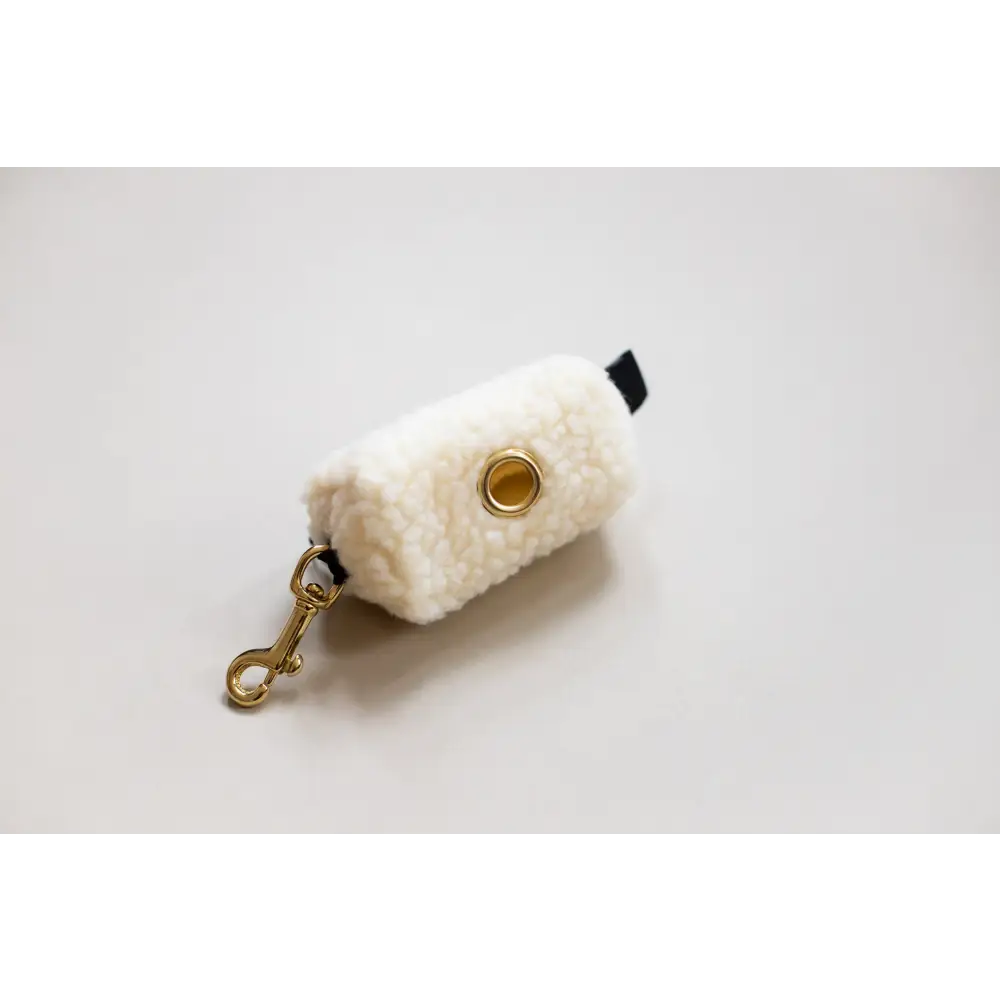 White fluffy Waste Bag Treat Holder keychain with solid brass hardware and black strap