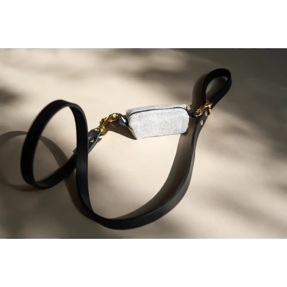 Black leather goggle-style sunglasses with gold solid brass hardware and concrete lens