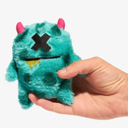 Teal plush dog toy Mr.X with pink horns and glittery black eyes