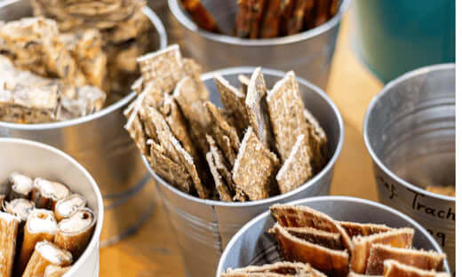 Tin can snack holder with brown crackers and white sticks from Natural Cornish Pet