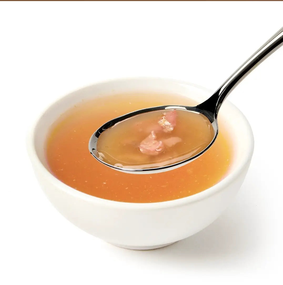 White Canagan cat soup in ceramic bowl with pink gelatin spoon