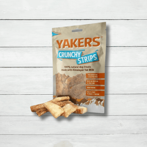 A pack of Yakers Crunchy Strips sits on a white rustic background