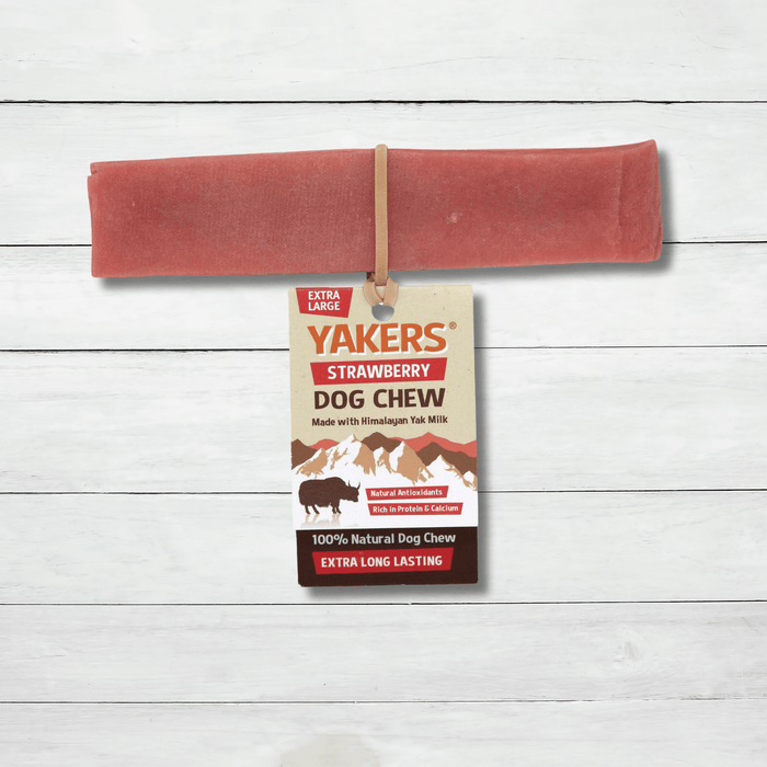 Yakers Strawberry Yak Chew sits on a rustic background. This product can be bought at The Pets Larder natural pet store