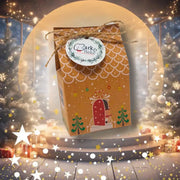 Golden gift box with reindeer, Christmas tree, and Clark Bake logo for mini gingerbread hoomans