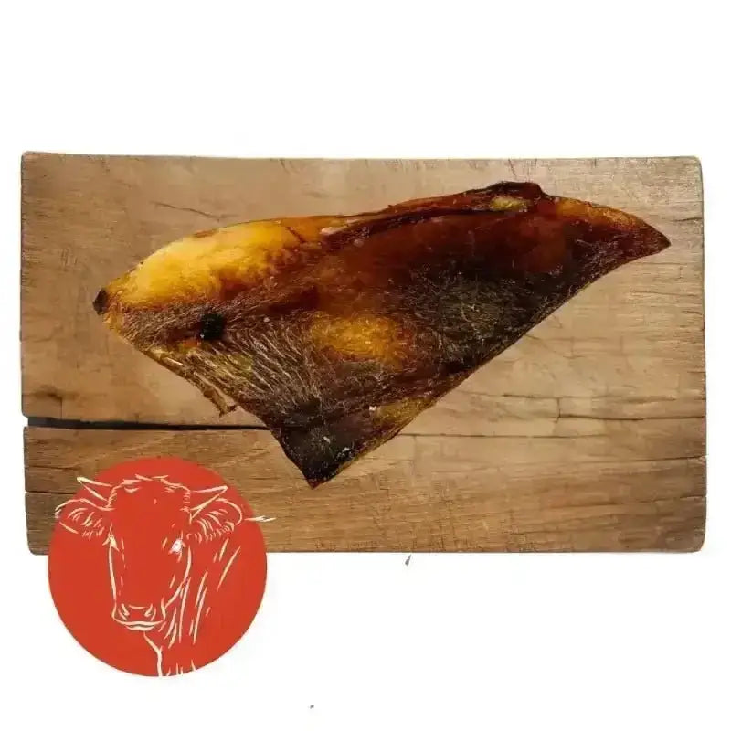 Smoked brisket on wooden board from Beef Moon bone chews