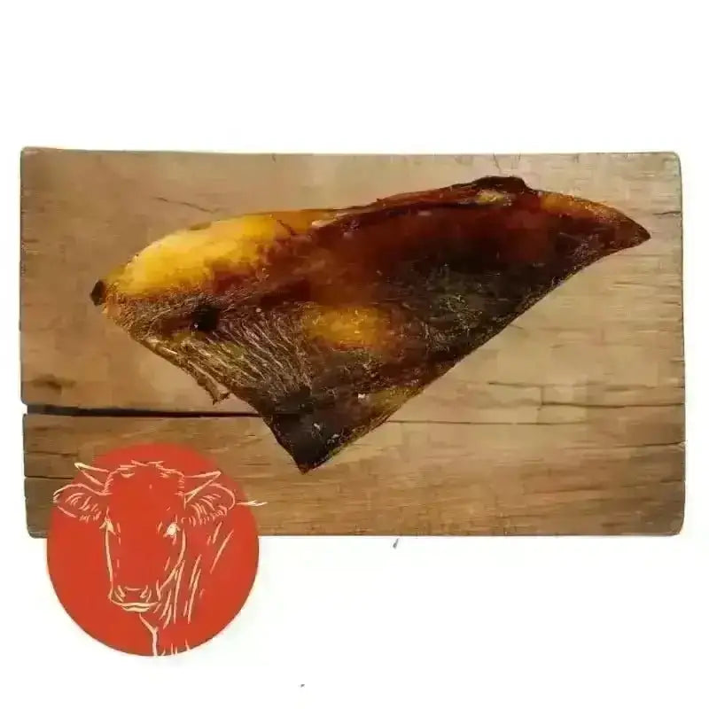 Smoked brisket on wooden board from Beef Moon bone chews