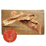 Leather jerky sticks with red cow logo on wooden board, ideal beef neck tendon dog chew