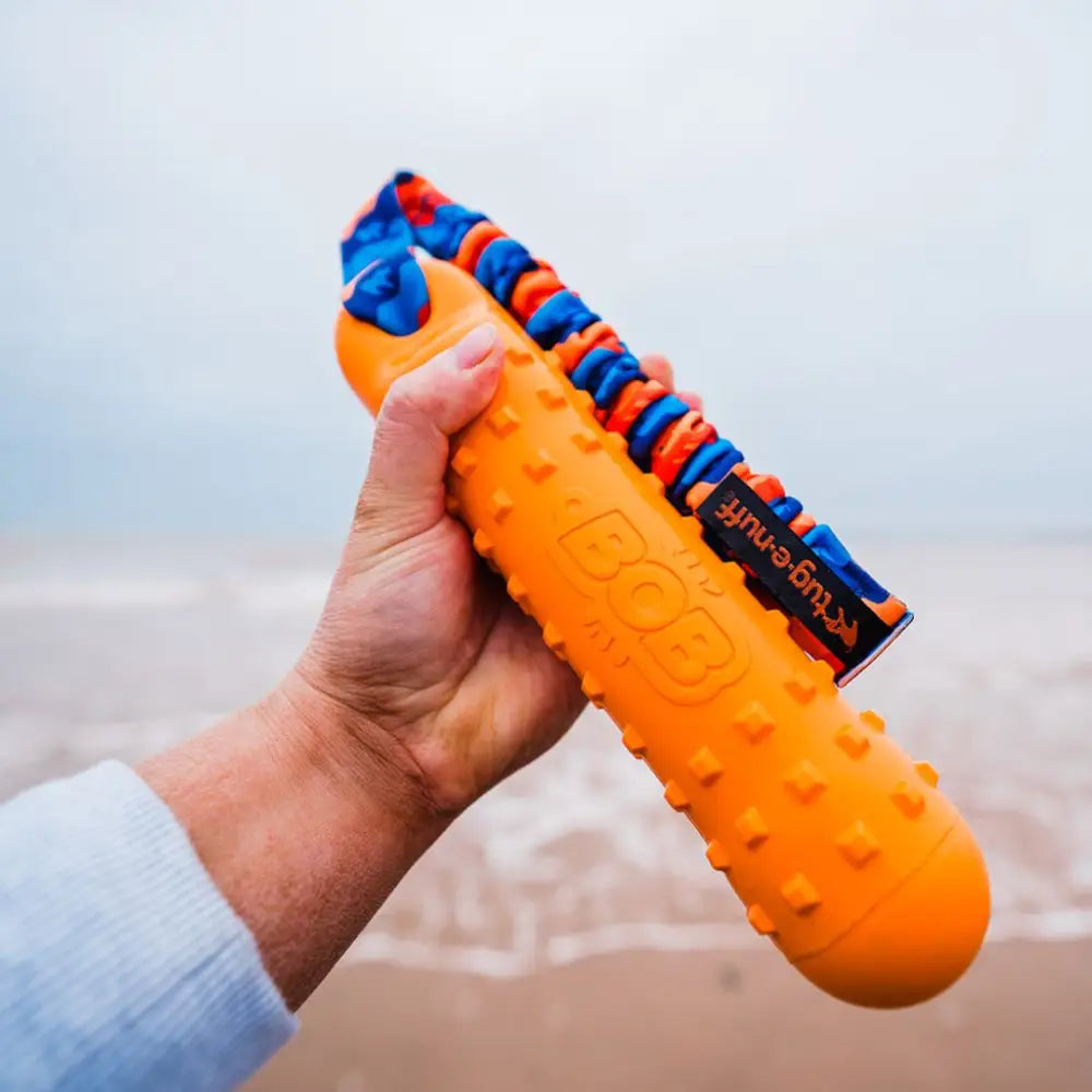 Orange dog dummy with blue and red accents, textured durable material from BOB dog dummy