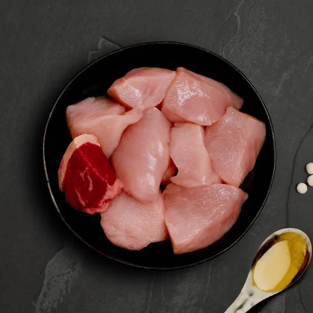 Raw chicken breast slices with red pepper and oil for Canagan Cat Food Can - Chicken with Beef