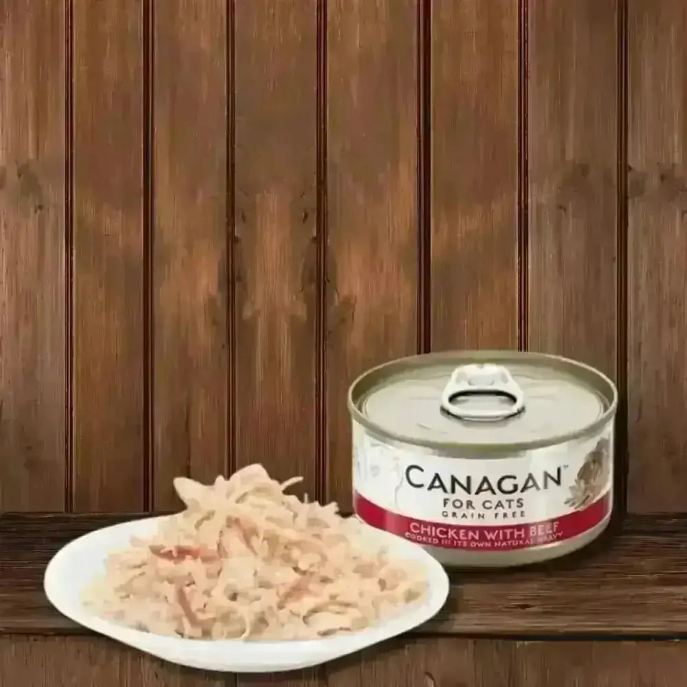 Canagan cat food can with chicken and beef flavor, tender shredded chicken on white plate
