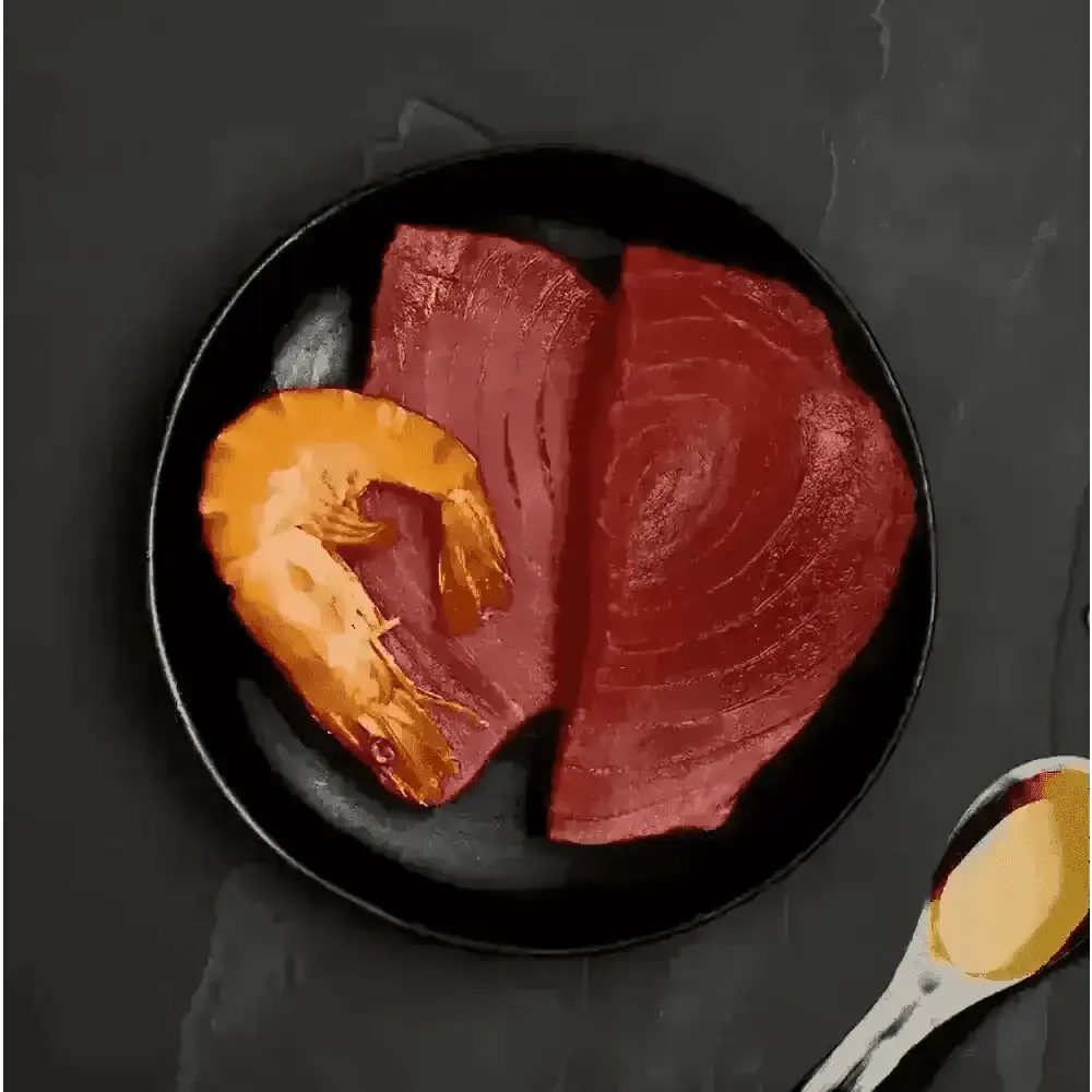 Black plate with raw tuna and prawns, oil-filled spoon, ideal for Canagan Cat Food Can
