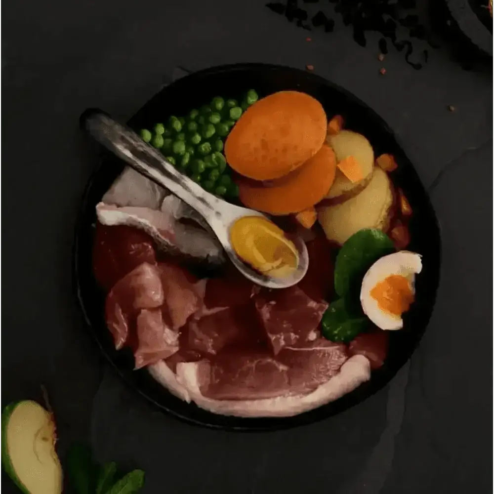 Canagan Country Game dog food in black bowl with duck, meats, veggies, eggs