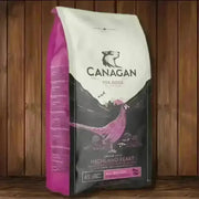 Canagan Highland Feast dog food bag with pink white packaging and bird illustration