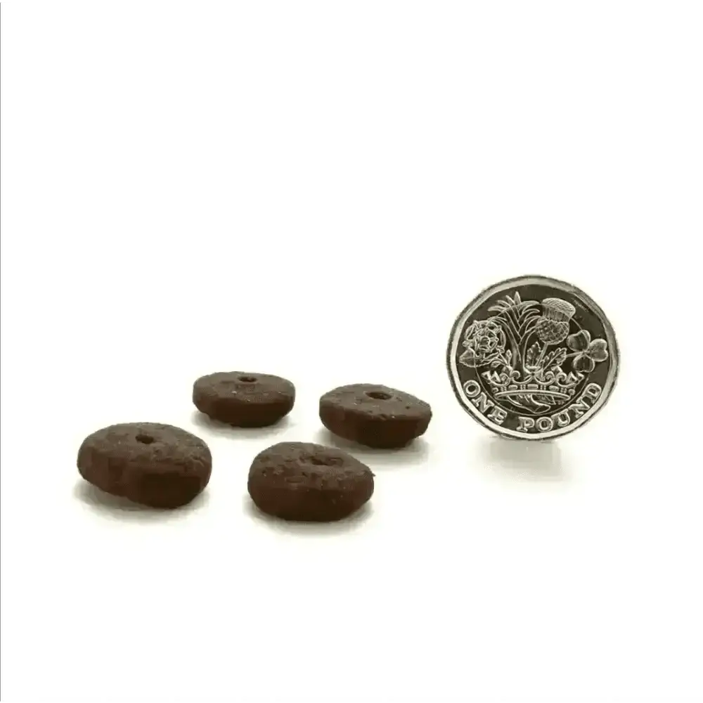 Round brown chocolate cookie dog treat with center hole for Canagan dry dog food