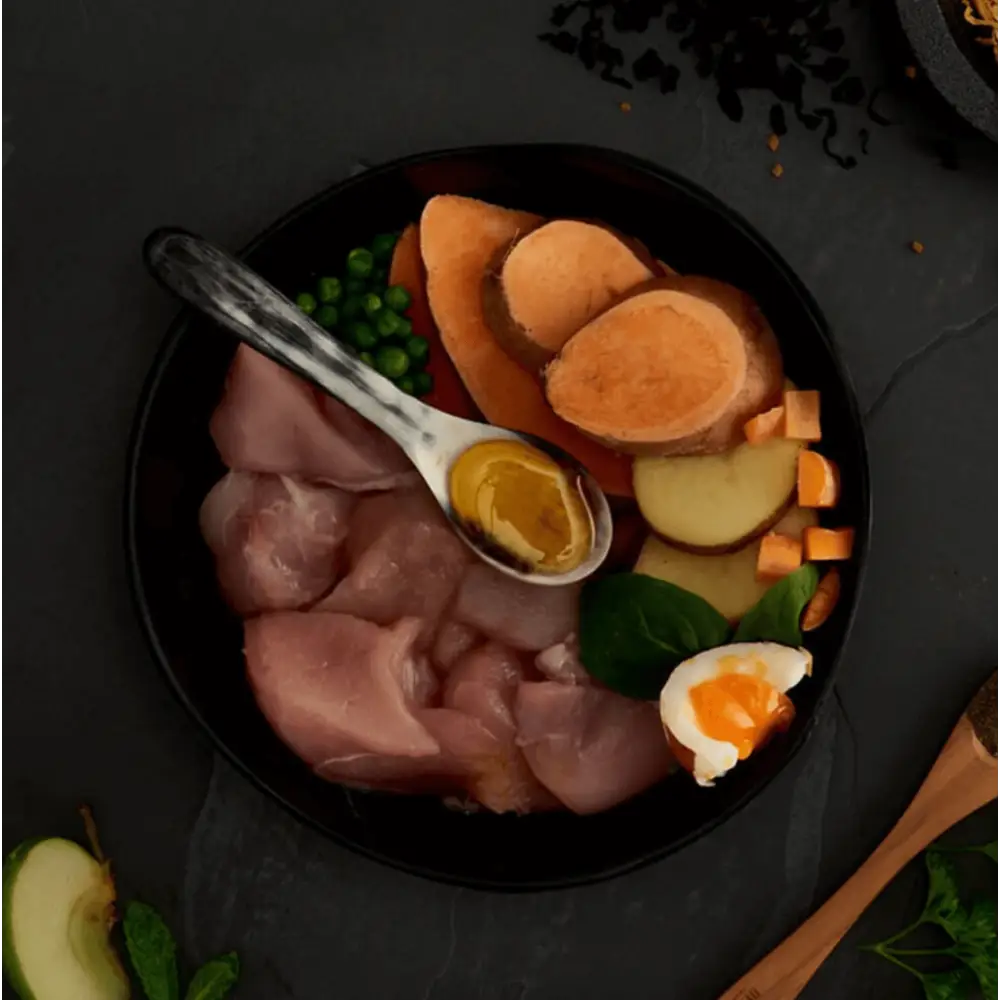 Black bowl with ham, sweet potato slices, and soft-boiled egg for Canagan Dry Dog Food Small Breed Dental with Proden PlaqueOff®