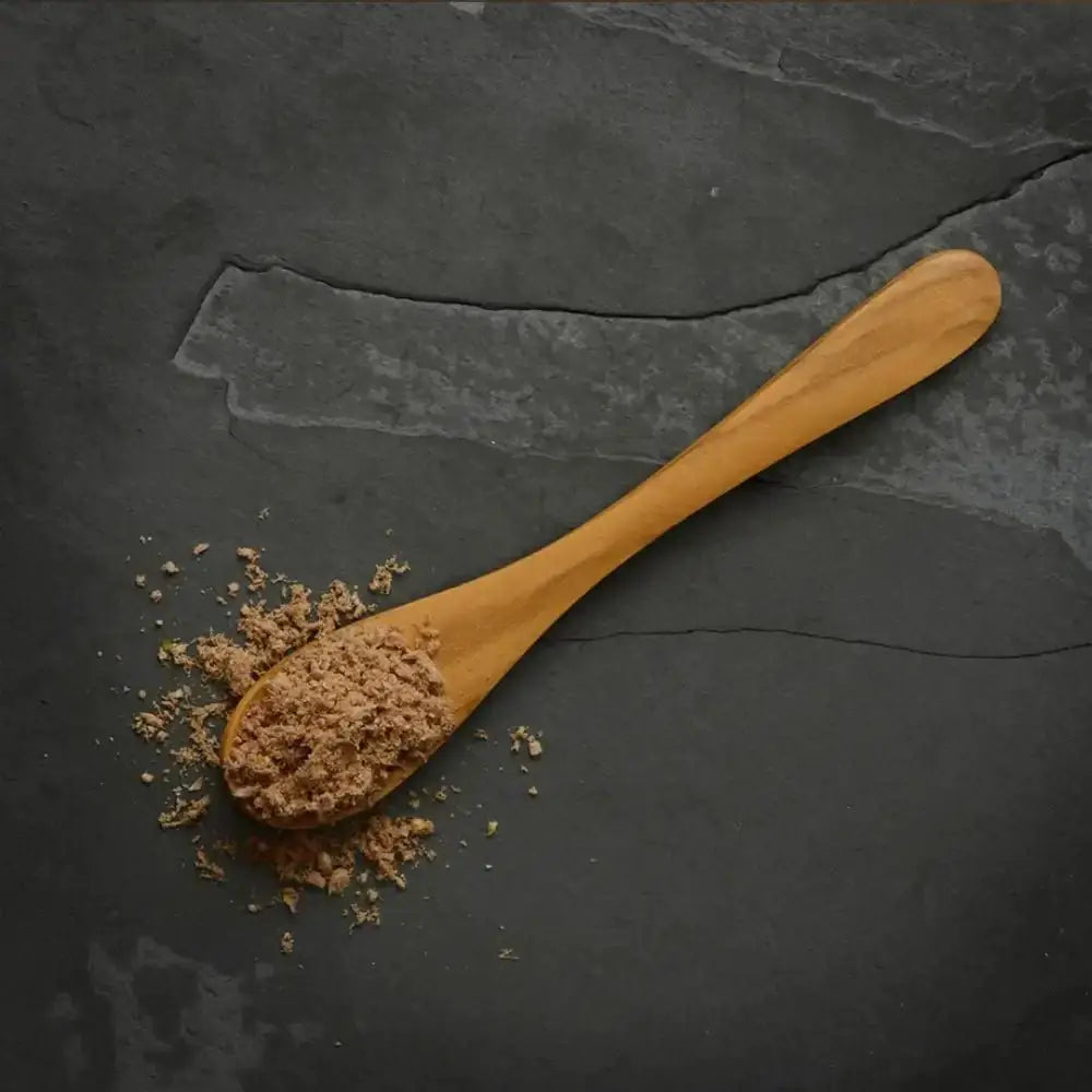 Canagan Raw Freeze-dried chicken topper on wooden spoon