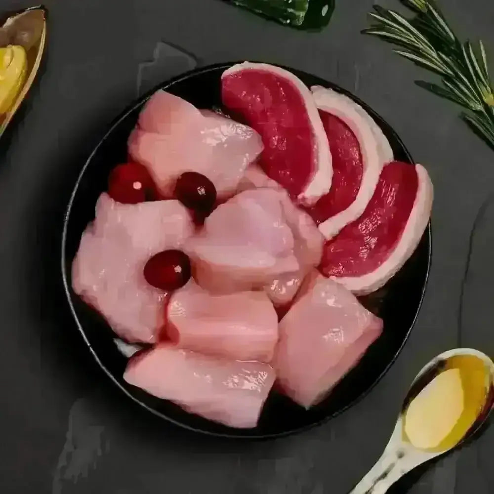 Canagan wet cat food pouch with raw chicken, duck and nutritious cranberries on black plate