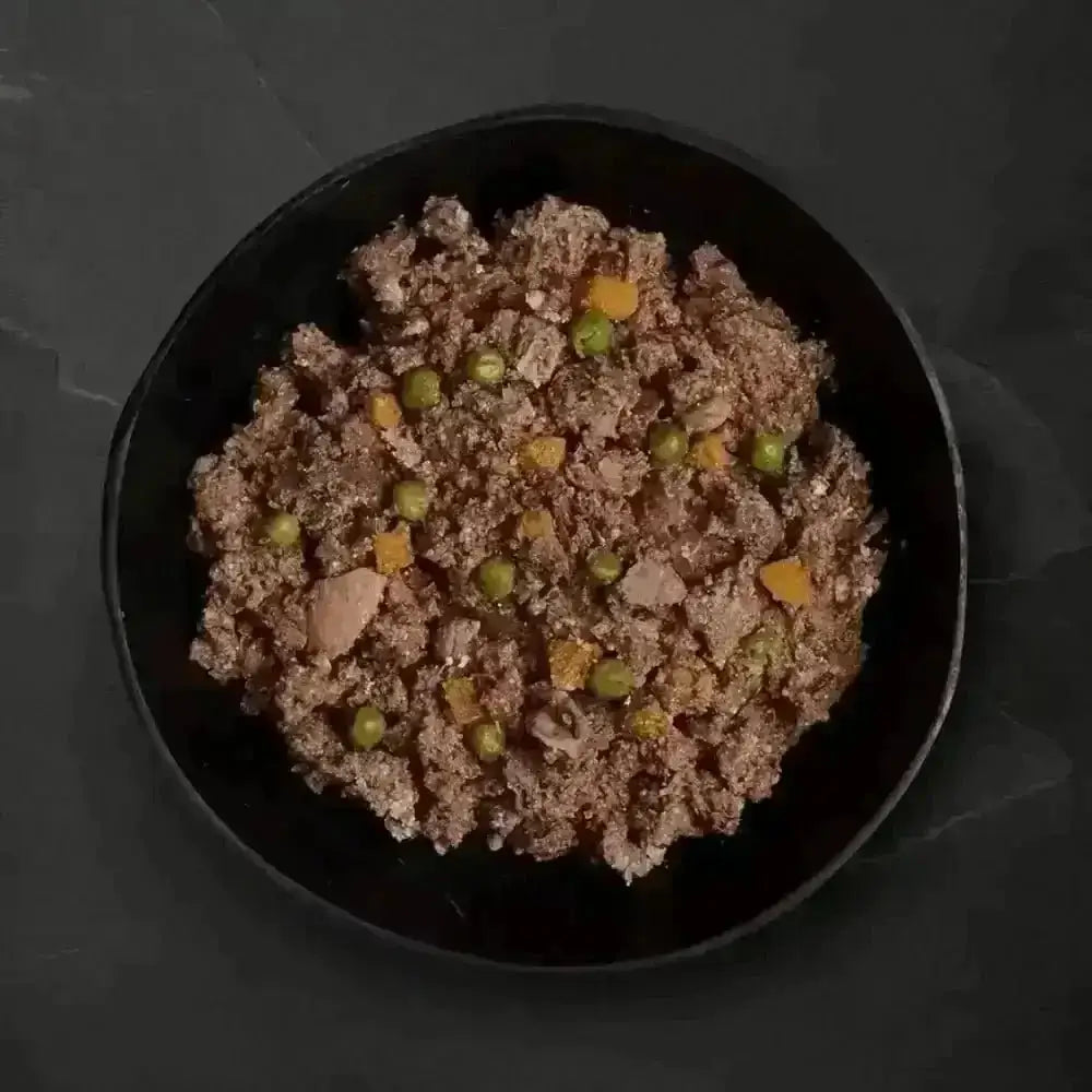 Black bowl with beef stew and vegetables from Canagan Wet Dog Food Can for dogs