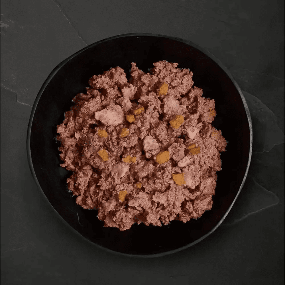 Dark bowl with textured pinkish-brown Canagan Wet Dog Food Can free run chicken