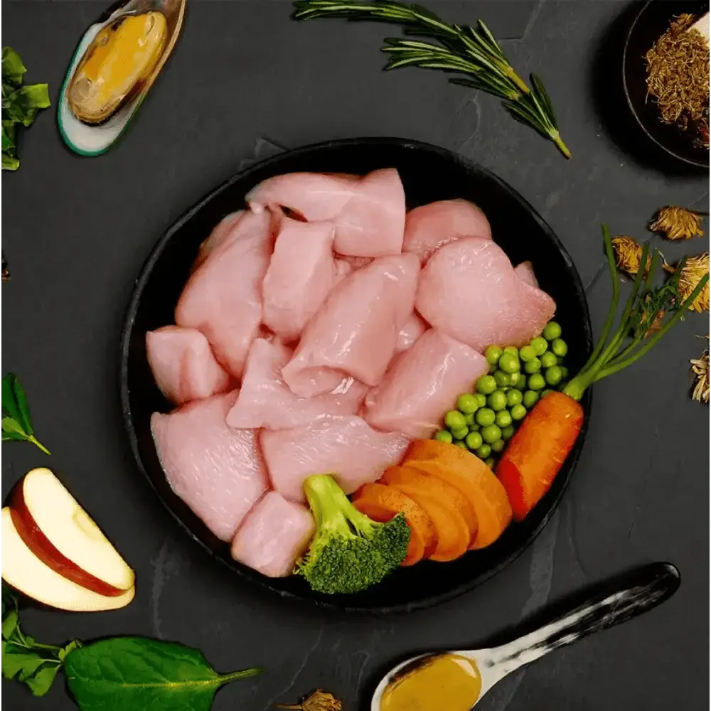 Black bowl with raw chicken and vegetables for Canagan Wet Dog Food Can Chicken Hotpot