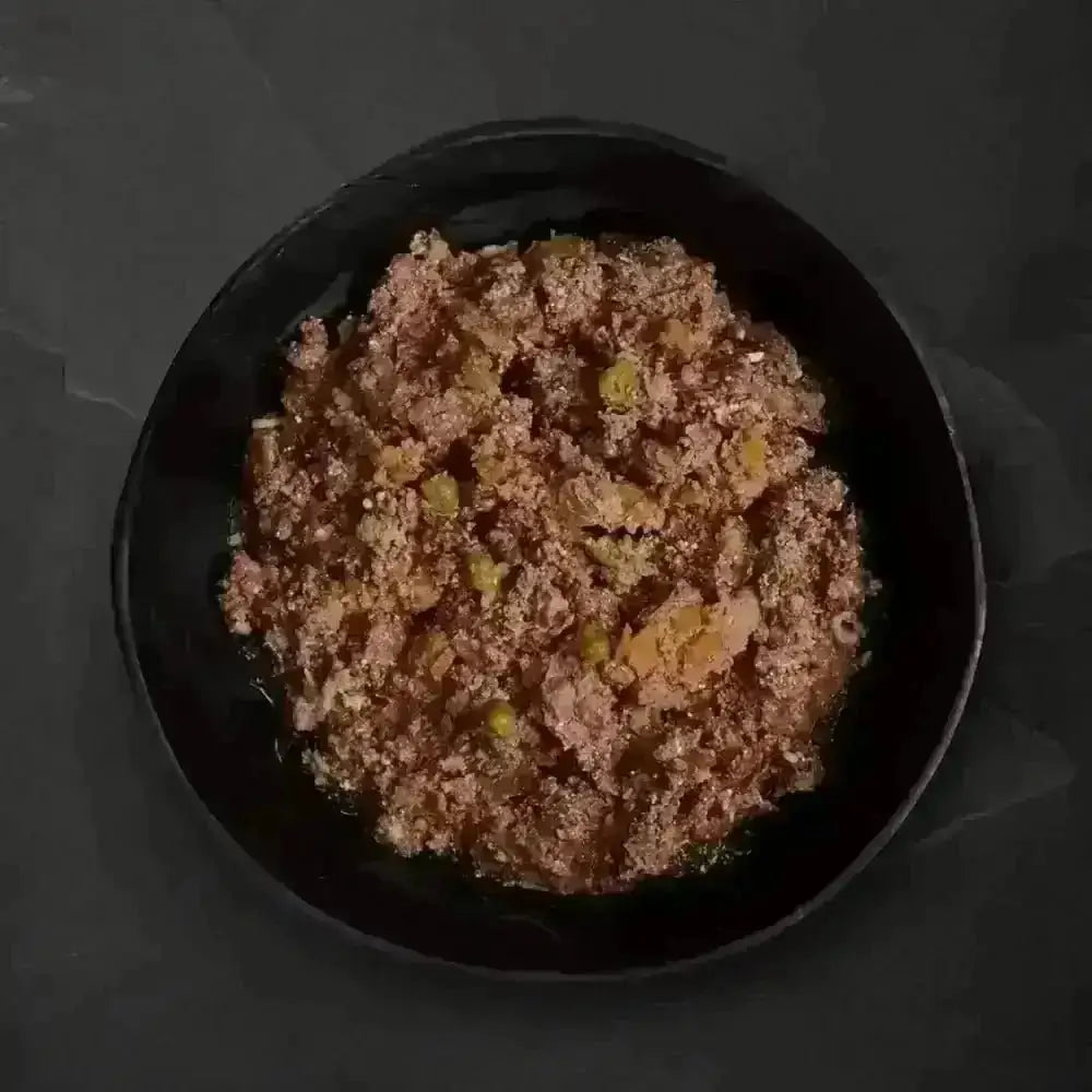 Canagan Puppy Feast black bowl with grain-free wet dog food and organic vegetables