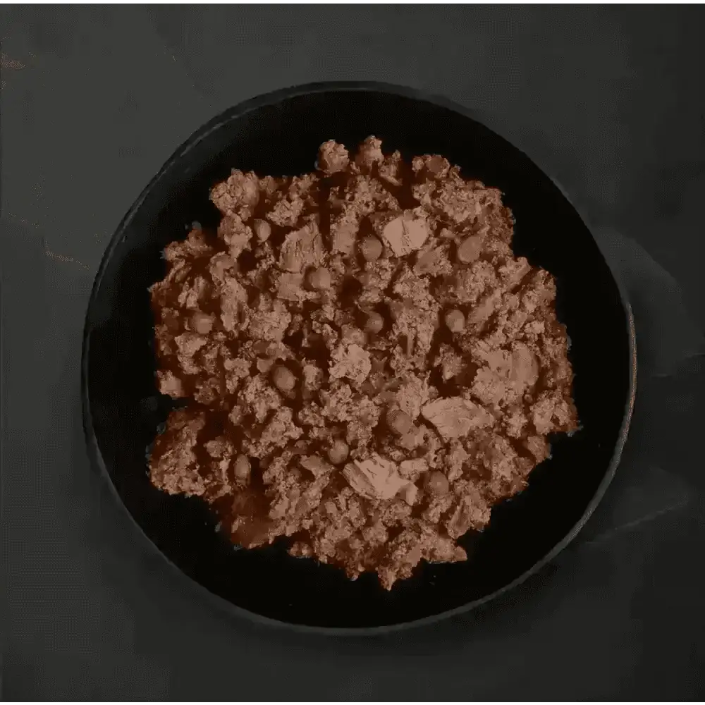 Black plate with ground beef and peas from Canagan Wet Dog Food Can Senior Feast