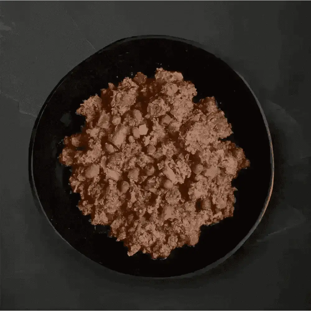 Black bowl with ground meat and vegetables for Canagan Wet Dog Food Can Shepherds Pie grain free