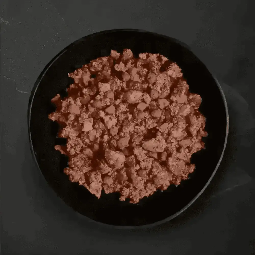 Black bowl with ground meat and peas from Canagan Wet Dog Food Variety Pack featuring freshly prepared deboned ingredients
