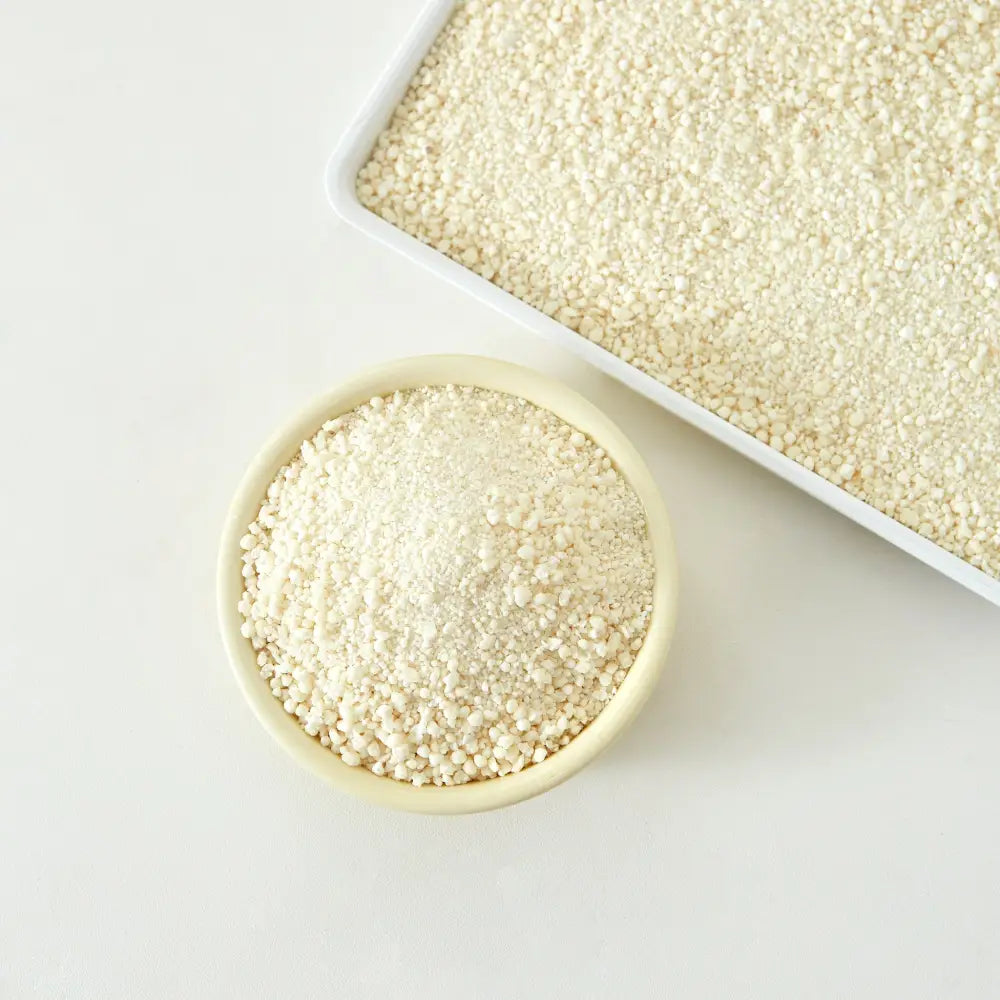 Creamy white cassava cat litter in textured bowl