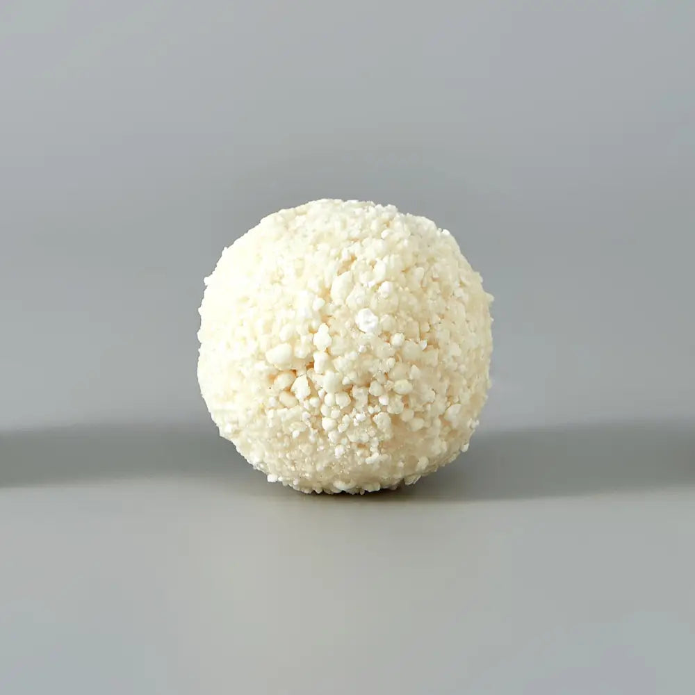 Cassava cat litter with white coconut-flake coated candy spheres