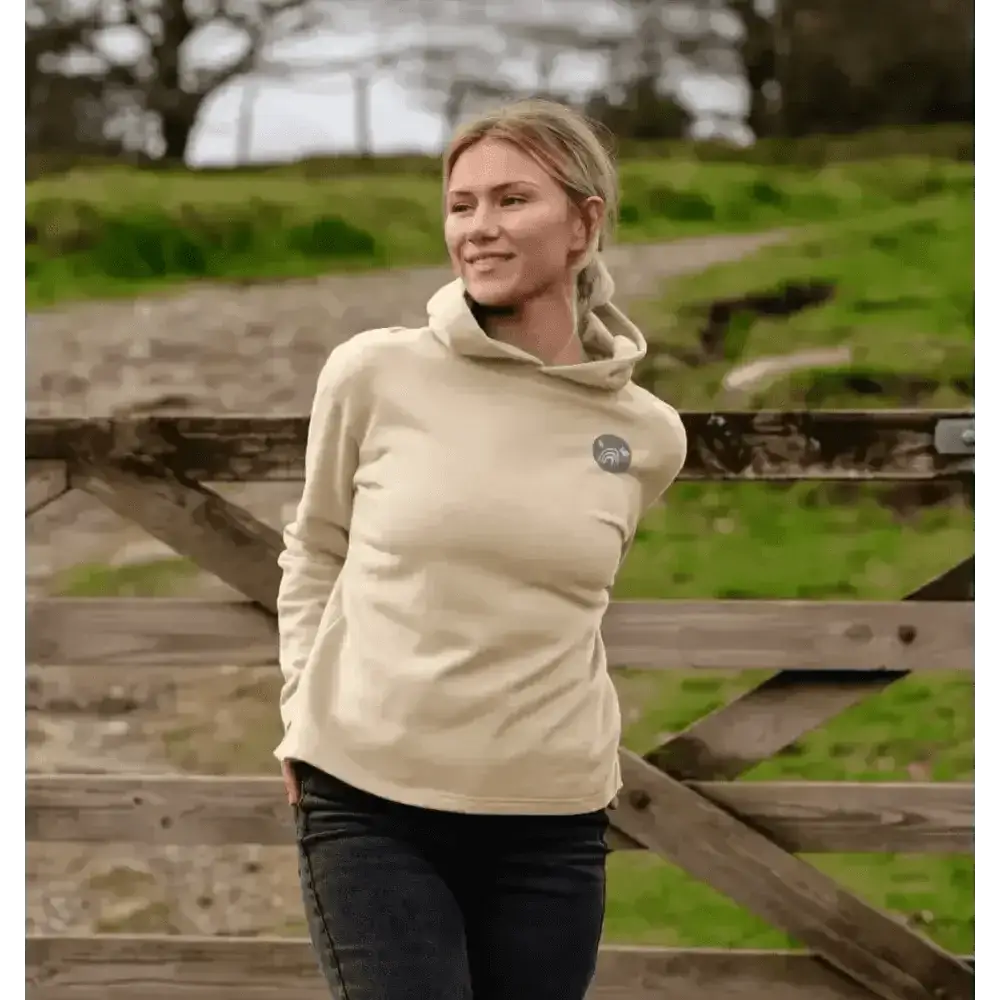 Beige certified organic cotton hooded sweatshirt with green logo and dark blue jeans