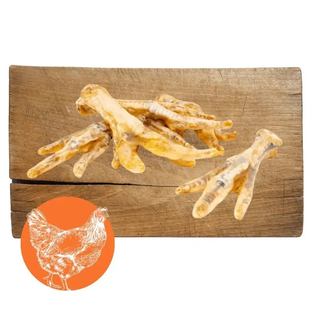 Bone-shaped chicken foot natural dog chew treats on wooden surface for dogs