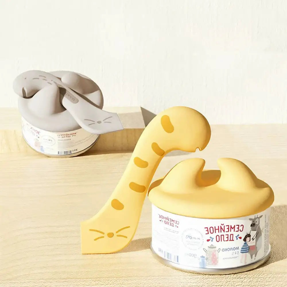 Yellow dinosaur-shaped tape dispenser with gray cat-themed design for Cococat silicone lid set