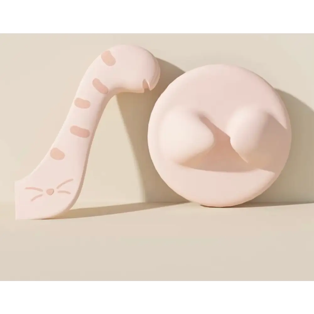 Pale pink cat-shaped teething toy with polka dots and tail from Cococat silicone lid set